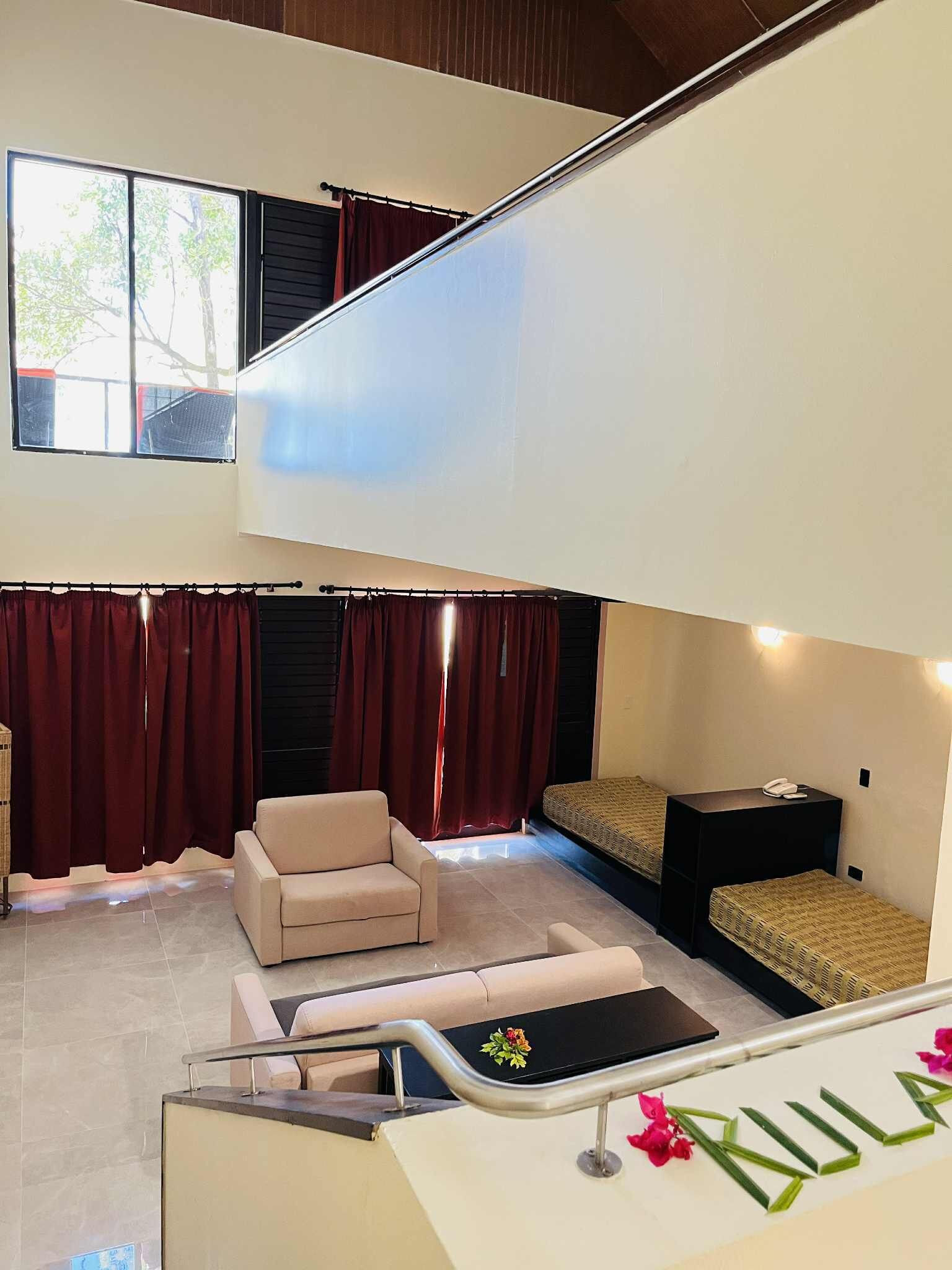 A spacious living area with a sofa, a coffee table, and a small side table.
