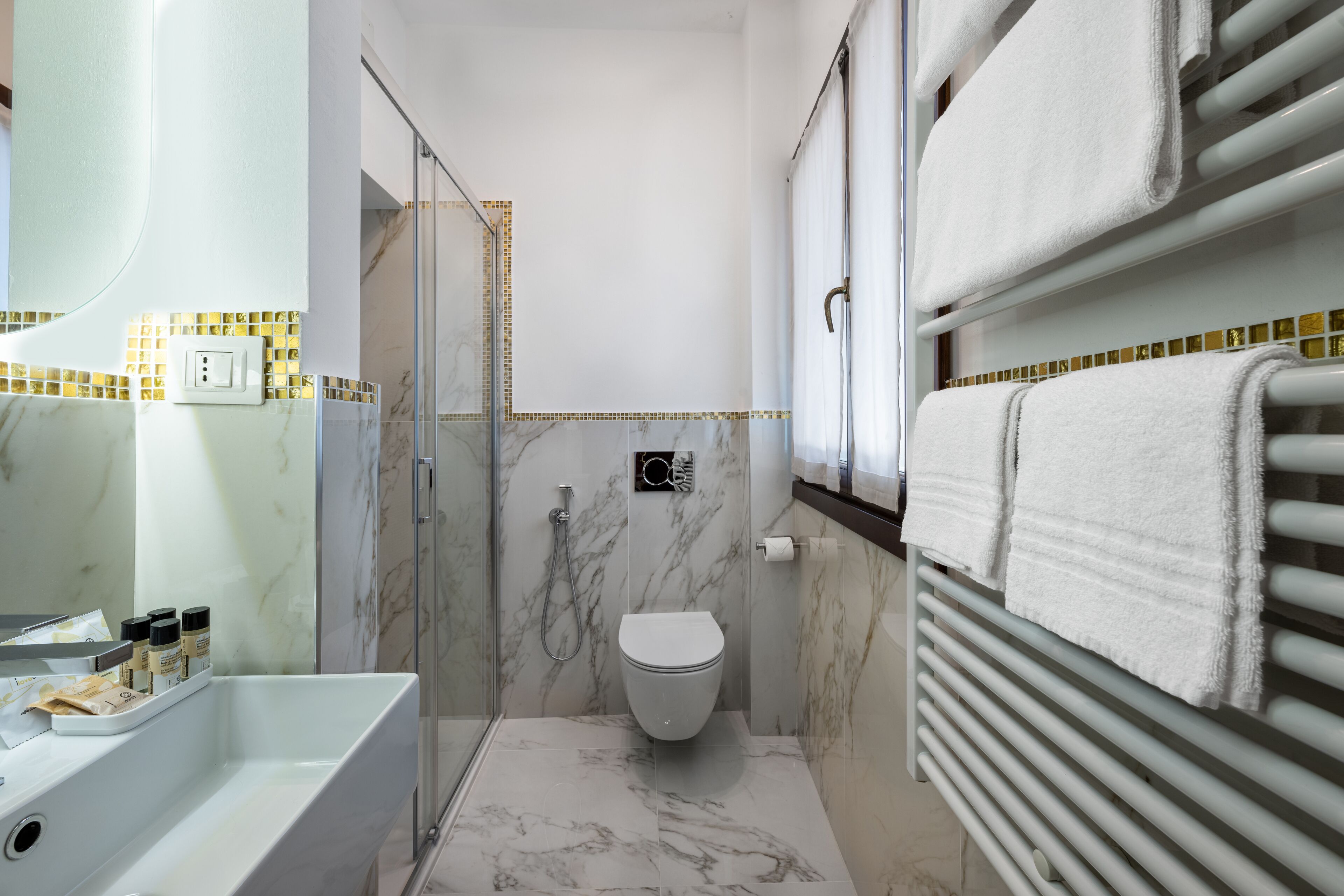 A bathroom with a bathtub, a toilet, and a glass-enclosed shower.