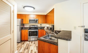 Full-size fridge, microwave, stovetop, coffee/tea maker at Mizner Place at Weston Town Center, Fort Lauderdale