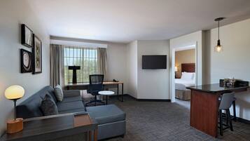 Premium bedding, desk, laptop workspace, blackout drapes
