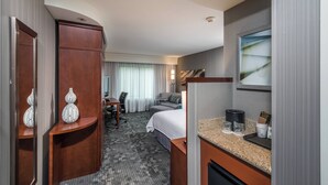 A hotel room with a bed, a desk, a chair, a vanity with a mirror, and a window with curtains. - Courtyard by Marriott Bangor (Bangor)