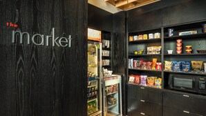 A store interior with shelves stocked with snacks and a refrigerator. - Courtyard by Marriott Bangor (Bangor)