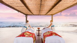 A beachside massage area with two massage beds under a wooden canopy, overlooking the ocean. - JW Marriott Guanacaste Resort & Spa (Tamarindo)