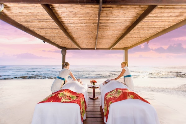 A beachside massage area with two massage beds under a wooden canopy, overlooking the ocean. - JW Marriott Guanacaste Beach Resort (Tamarindo)