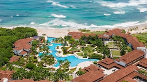 A resort with a central swimming pool, beachfront villas, and a beach. - JW Marriott Guanacaste Resort & Spa (Tamarindo)