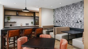 A modern interior with a bar area, seating, and a patterned wall. - Hampton Inn Manhattan-35th St/Empire State Bldg (New York)