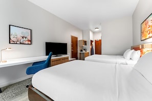 A hotel room with a bed, a desk, a chair, a television, and artwork on the walls. - Hilton Garden Inn Warner Robins (Warner Robins)