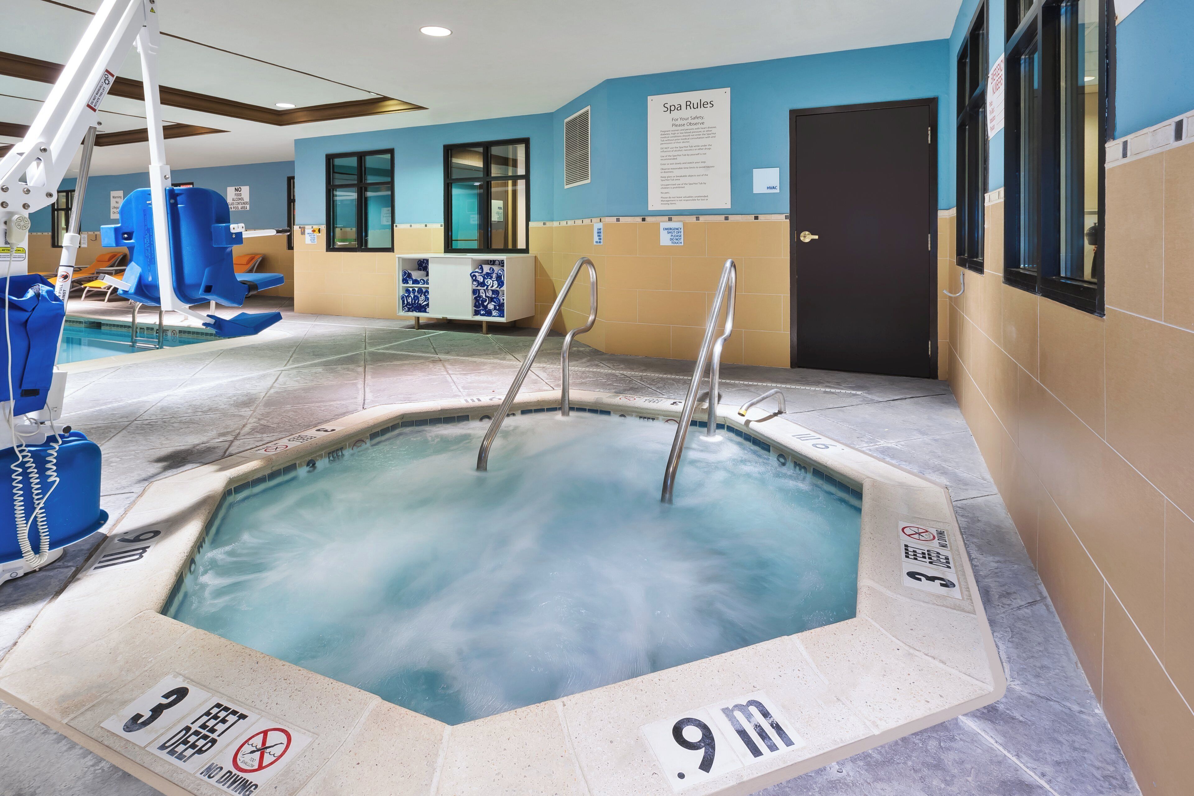 A hot tub with a sign indicating a depth of 9 meters and a '3 feet deep' warning.