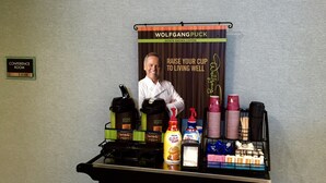 A coffee station with coffee makers, cups, and condiments. - Boarders Inn & Suites by Cobblestone Hotels – Ashland City (Ashland City)