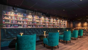 A library with bookshelves, teal chairs, and a wooden floor. - Thon Hotel Panorama (Oslo)