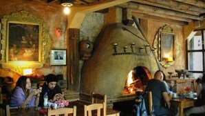 A rustic interior with stone walls, wooden furniture, and a traditional wood-fired oven. - Hotel Hacienda Don Juan  (San Cristóbal de las Casas)
