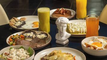 A dining table with various dishes including eggs, meat, and vegetables, along with drinks and a bust sculpture.