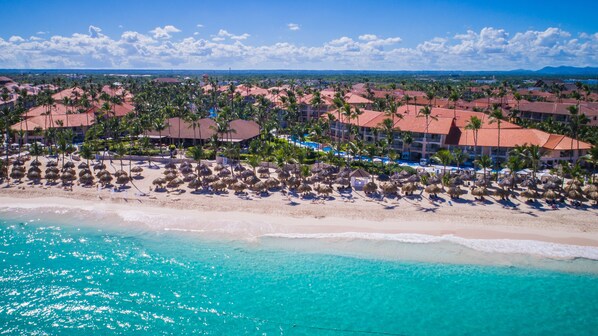 A resort with beach access, palm trees, and a clear blue sky. - Majestic Elegance Punta Cana - All Inclusive (Punta Cana)