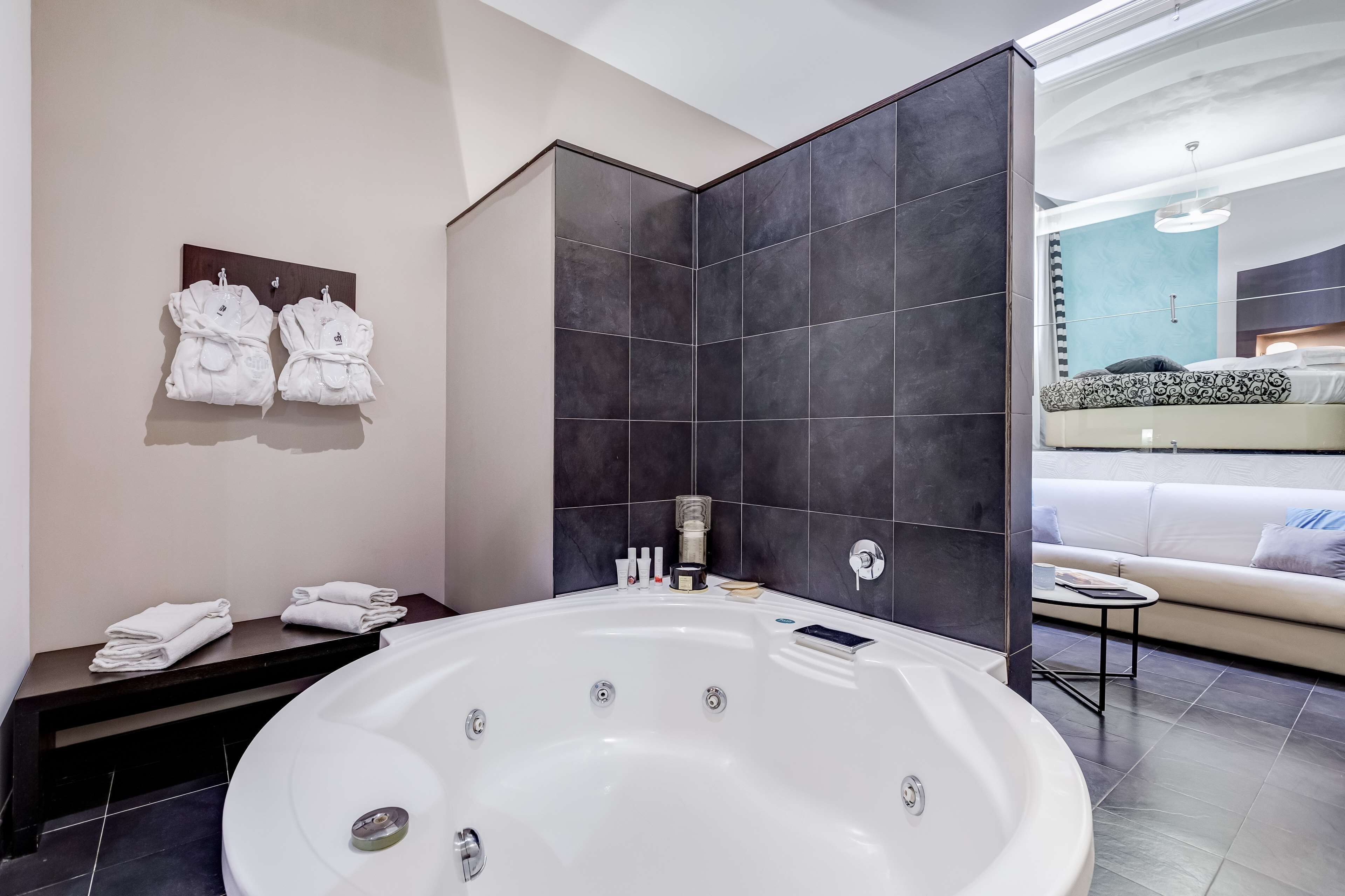 suite, 1 king bed, hot tub | bathroom | rainfall showerhead, free toiletries, hair dryer, slippers