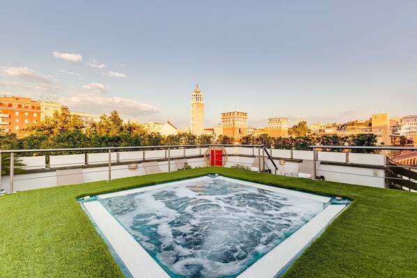 A rooftop pool with a view of a historic tower and surrounding buildings. - Best Western Cinemusic Hotel (Rome)