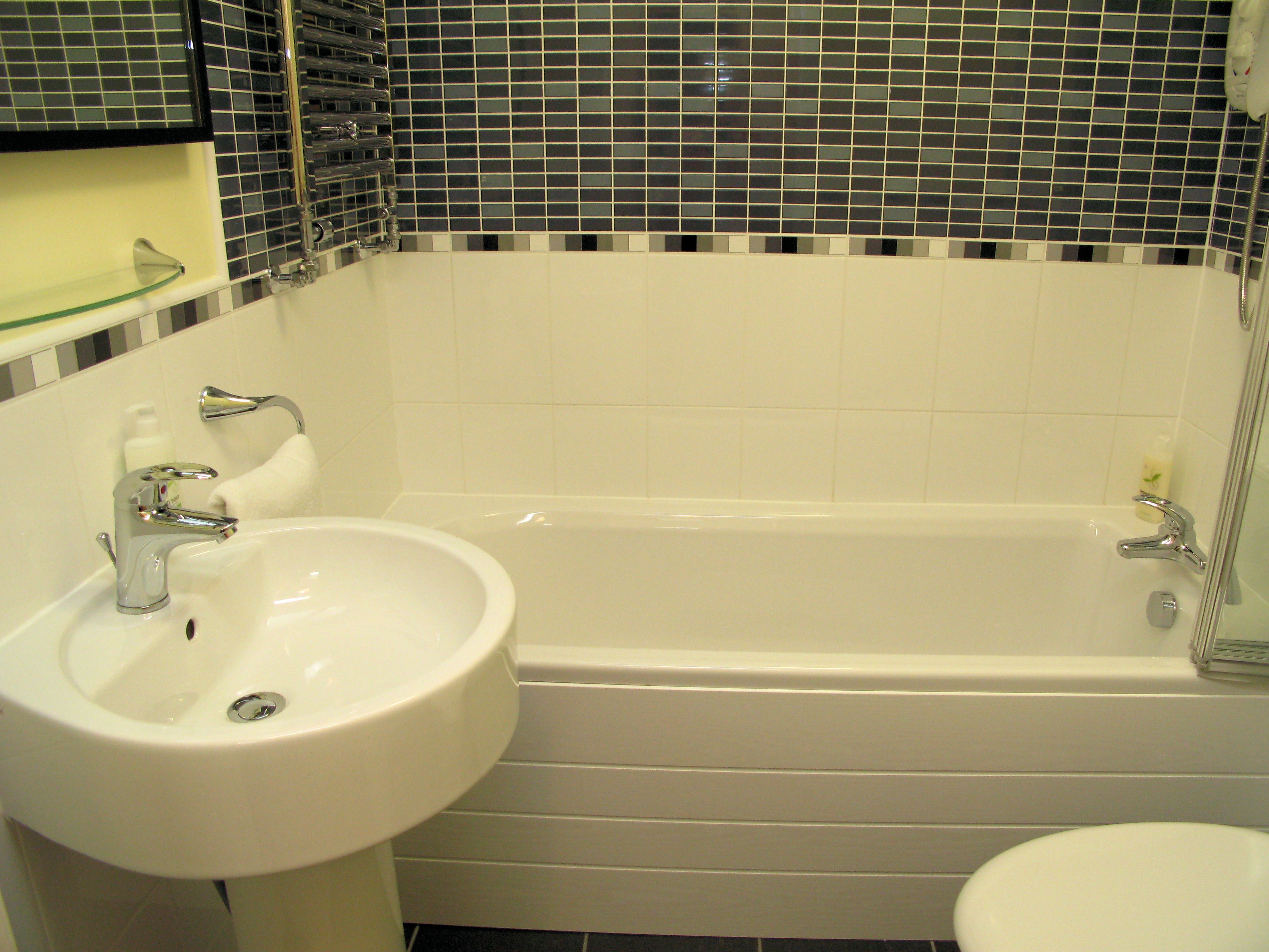 Un baño con un lavabo blanco, una bañera y un inodoro.