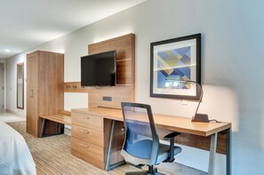 A modern hotel room with a wooden desk, a flat-screen TV, a framed abstract artwork, and a bed. - Holiday Inn Express & Suites, Lake Elsinore by IHG (Lake Elsinore)