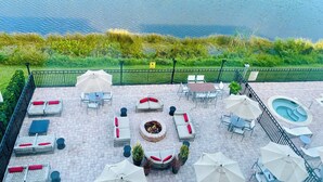 An outdoor patio with seating, a fire pit, and a pool area.