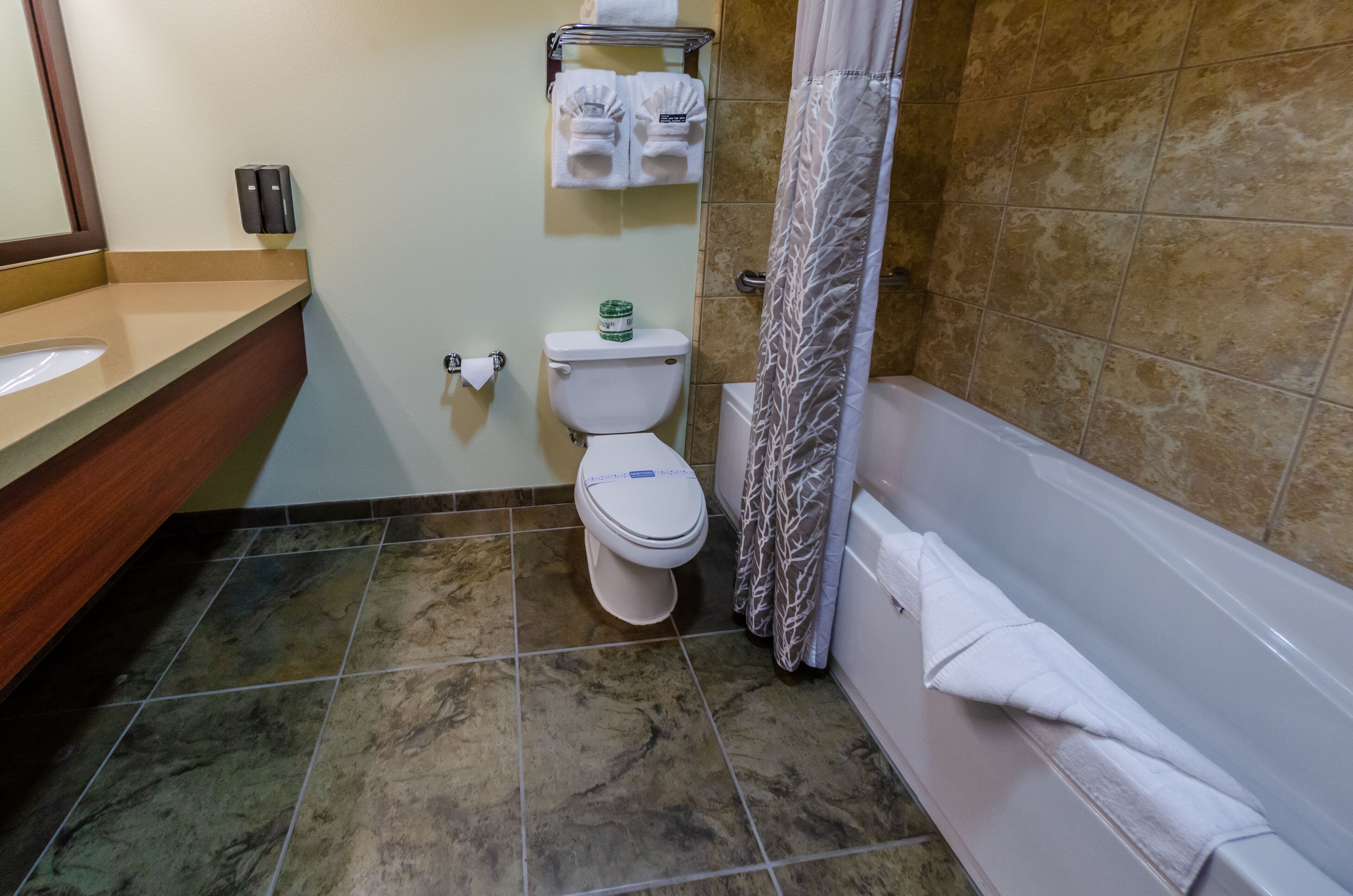 A bathroom with a toilet, sink, and bathtub.