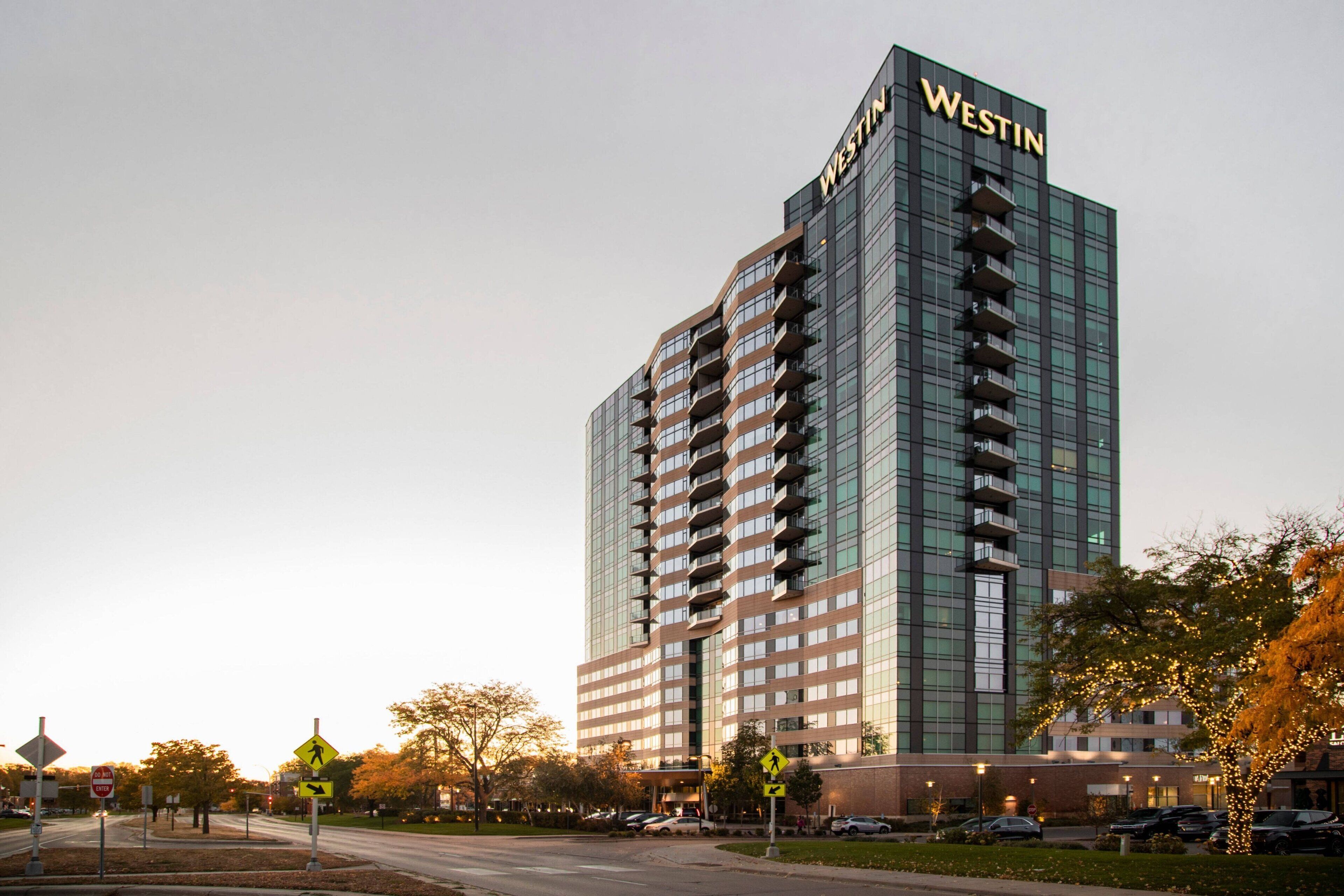 A tall, modern hotel building with the name "WESTIN" on the facade.