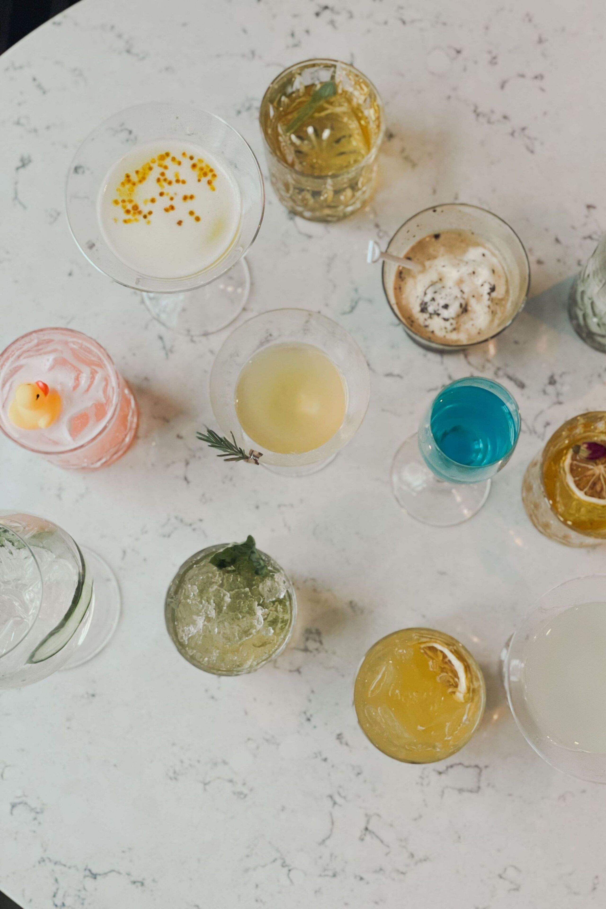 A variety of drinks on a marble table.