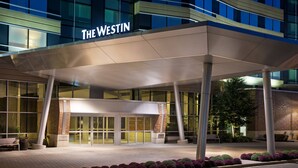 A hotel entrance with a covered walkway, glass doors, and a sign reading "The Westin". - The Westin Edina Galleria (Edina)