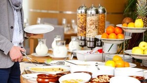 A buffet setup with various food items and condiments. - St Christophe Hotel & Spa, an Ascend Collection Hotel (Granby)