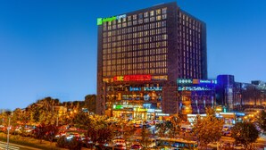 A high-rise hotel with multiple floors, large windows, and a prominent Holiday Inn Express sign. - Holiday Inn Express Beijing Wangjing Center by IHG  (Beijing)