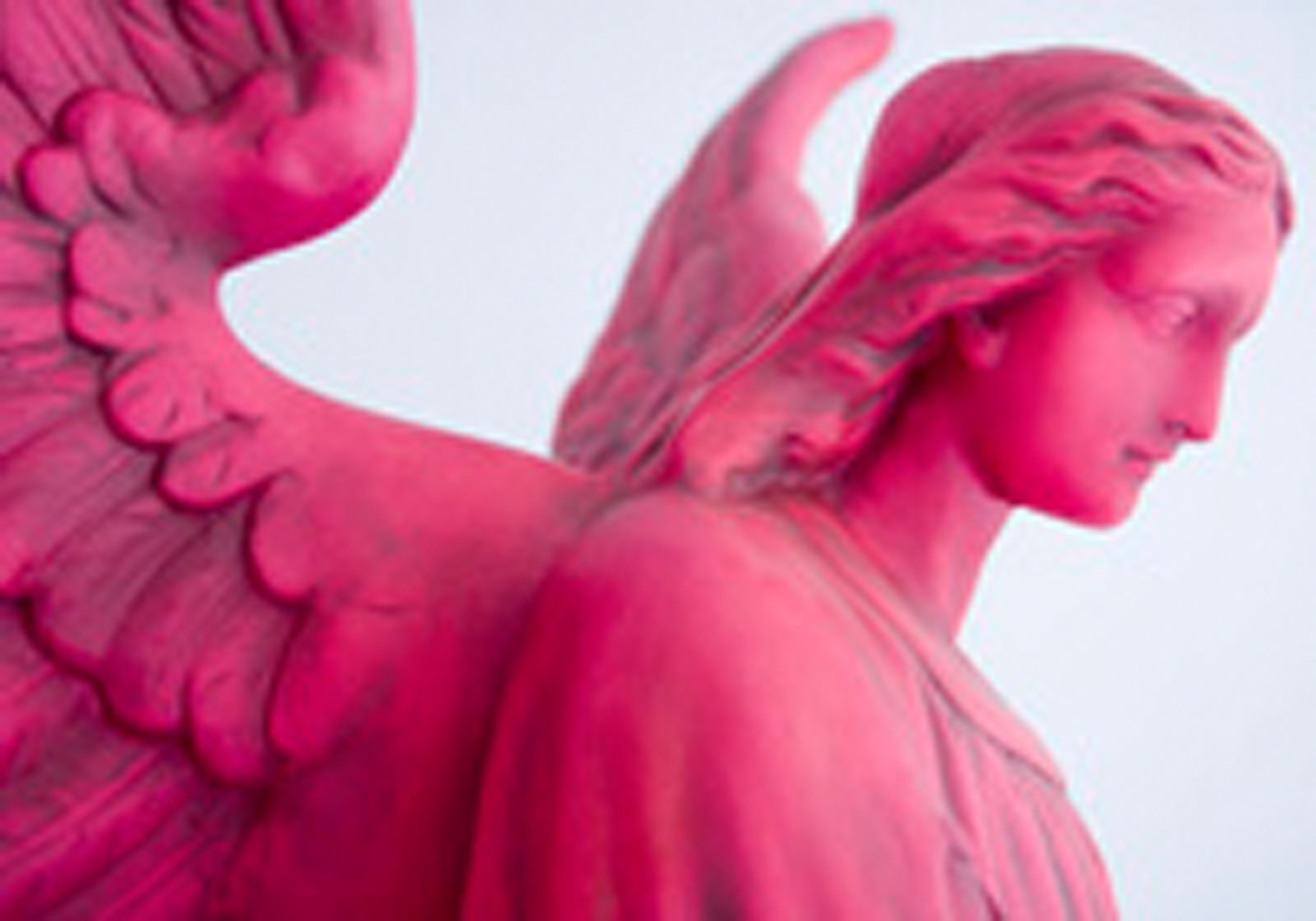 A statue with wings and a head turned to the side.