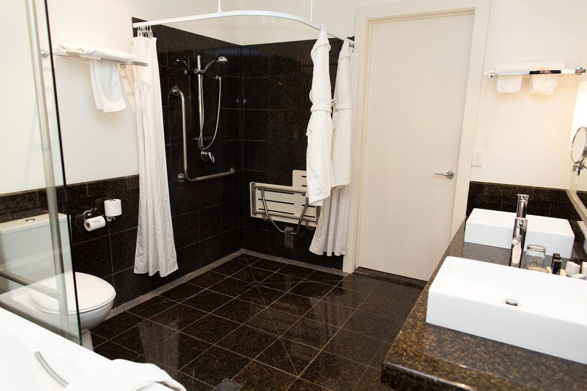 accessible spa suite | bathroom | separate bathtub and shower, jetted bath, designer toiletries