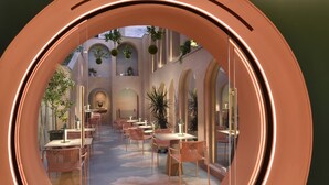 A circular view of a dining area with tables and chairs, arched ceilings, and hanging plants. - Leon's Place Hotel (Rome)