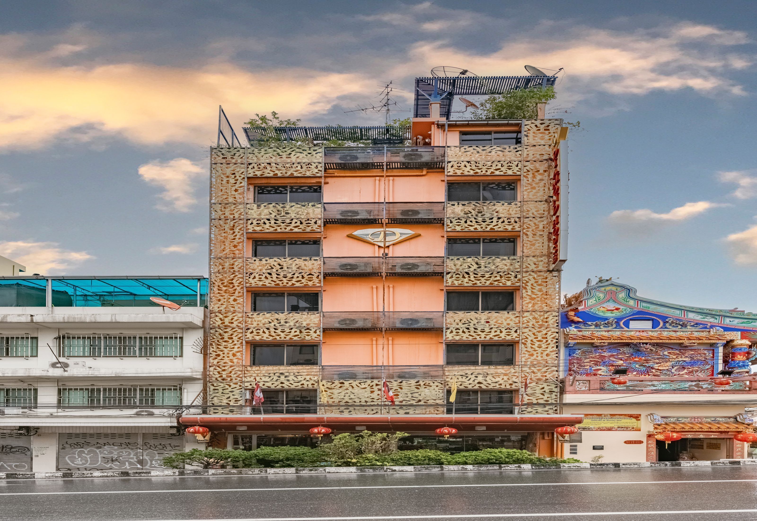A multi-story building with a distinctive facade featuring intricate patterns and a central emblem.