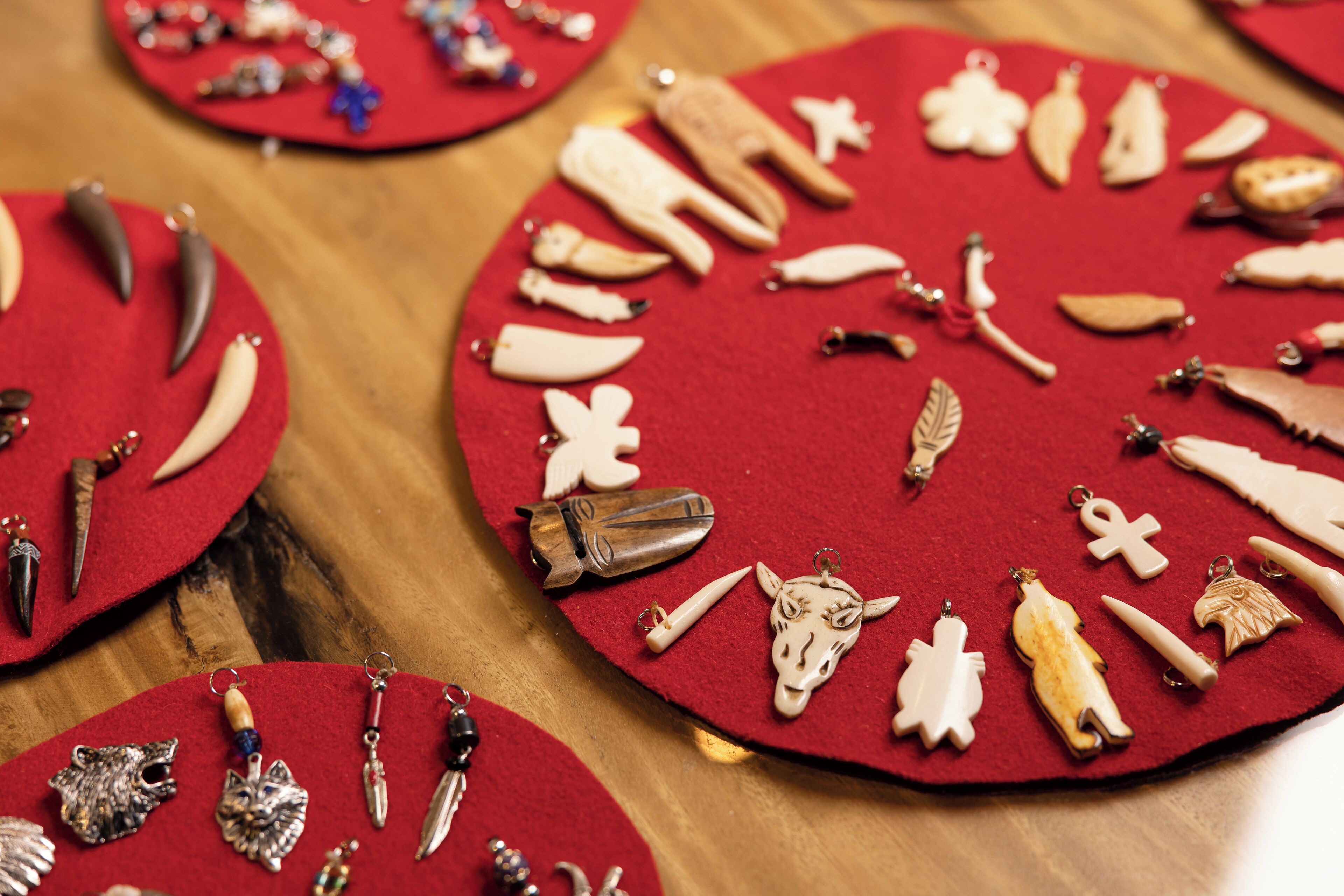A display of various jewelry items on red felt mats.