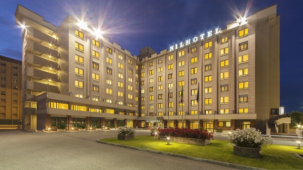 A multi-story hotel with a modern design, featuring a prominent 'Hilton' sign on the facade. - NilHotel Florence (Florence)