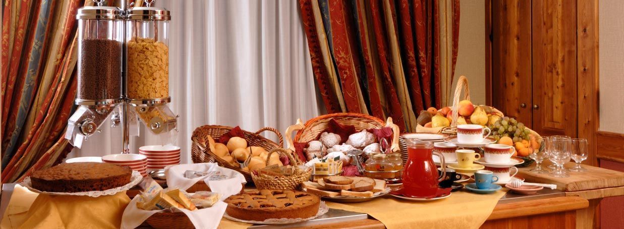 A breakfast buffet with various food items and beverages.