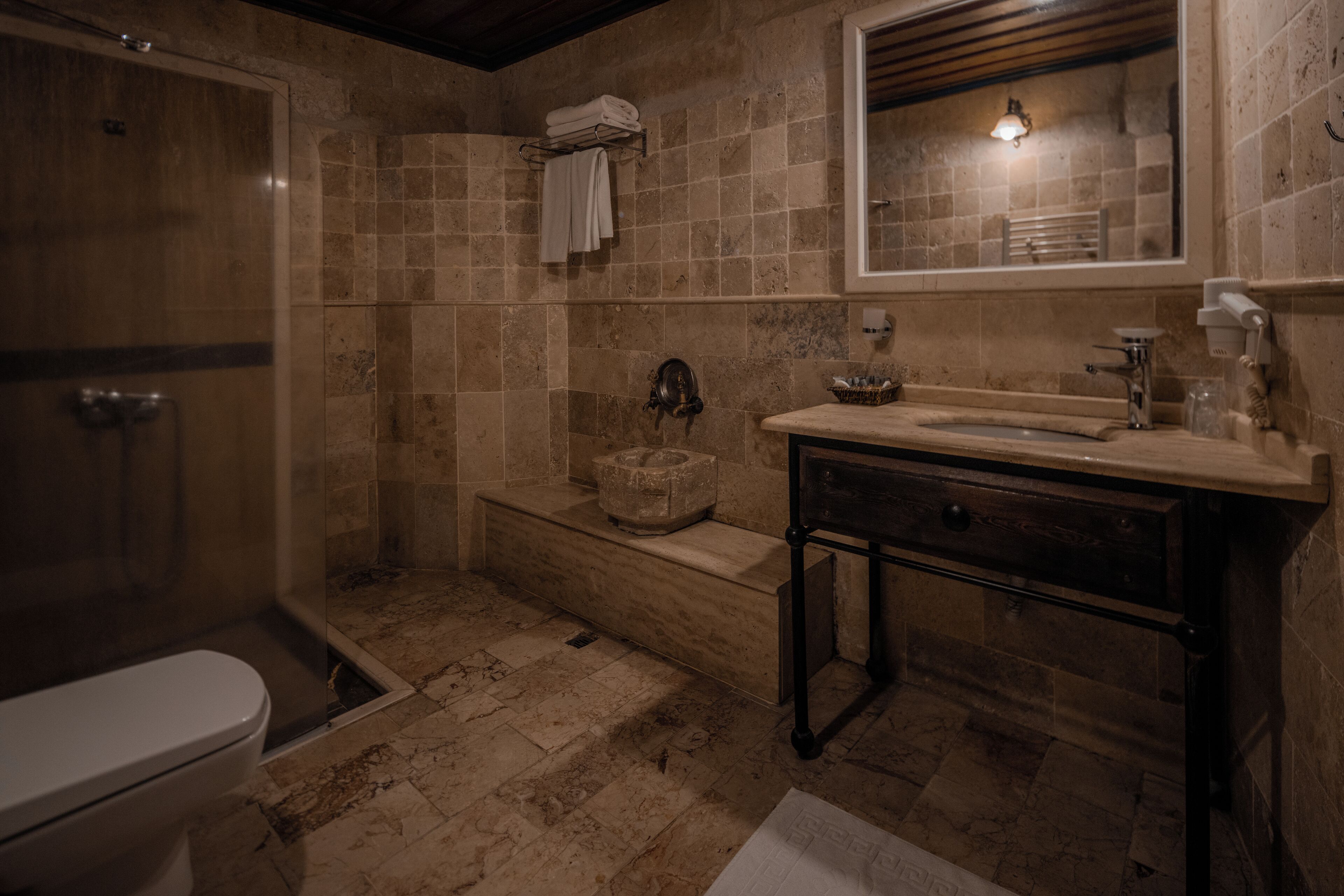 A bathroom with a shower, toilet, sink, and bathtub.
