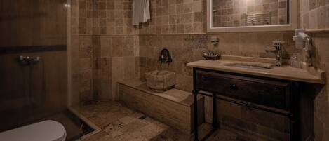 A bathroom with a shower, toilet, sink, and bathtub.