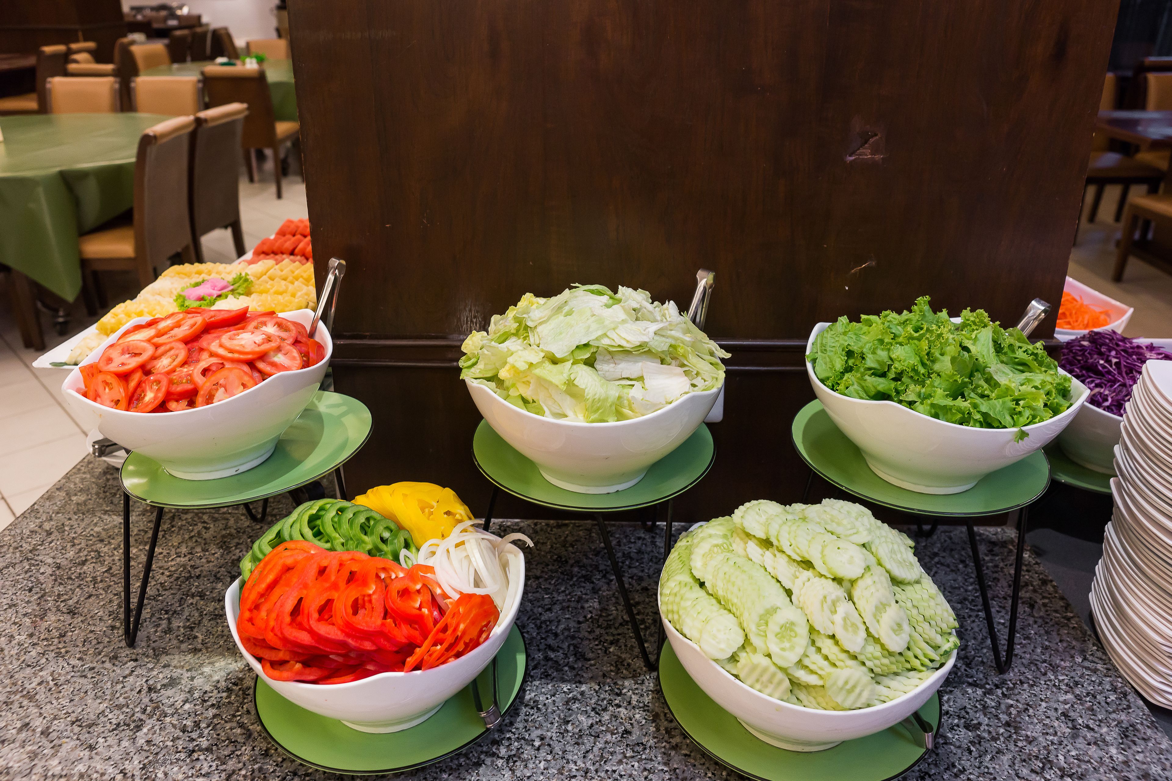 A buffet with various salads and vegetables.