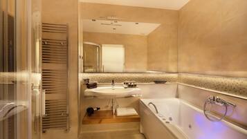 A modern bathroom with a glass shower enclosure, a sink, and a bathtub.