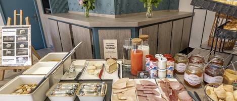 A variety of cheeses, meats, and condiments on display in a shop.