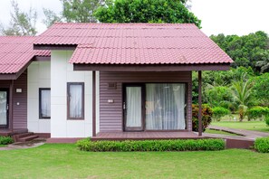 A two-story house with a red-tiled roof, large windows, and a covered porch. - Mayang Sari Beach Resort (Bintan)
