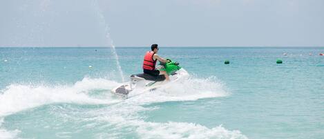 A person jet skiing on a clear day.