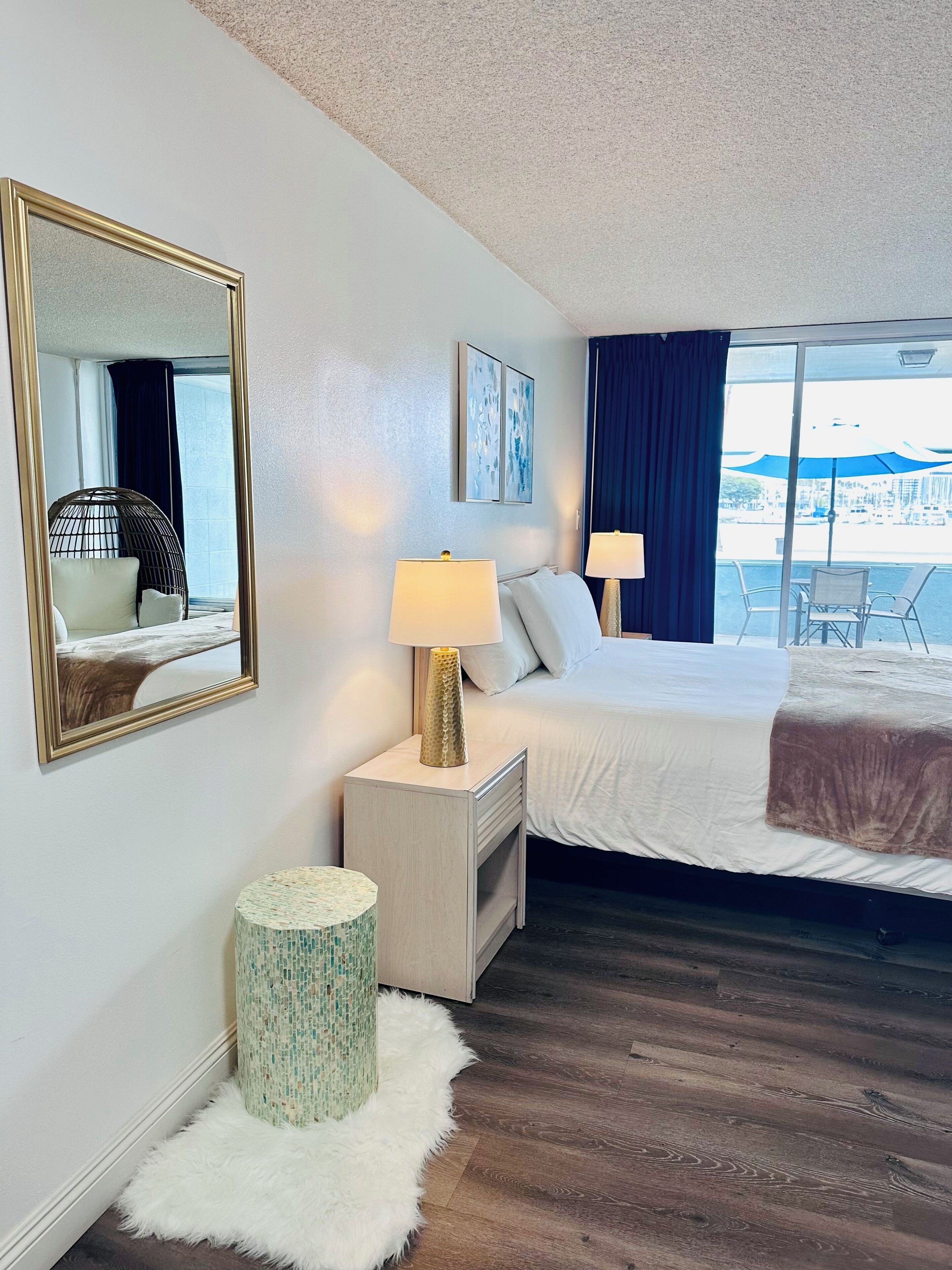 romantic room, 1 king bed, patio, marina view | down duvets, individually decorated, desk, laptop workspace