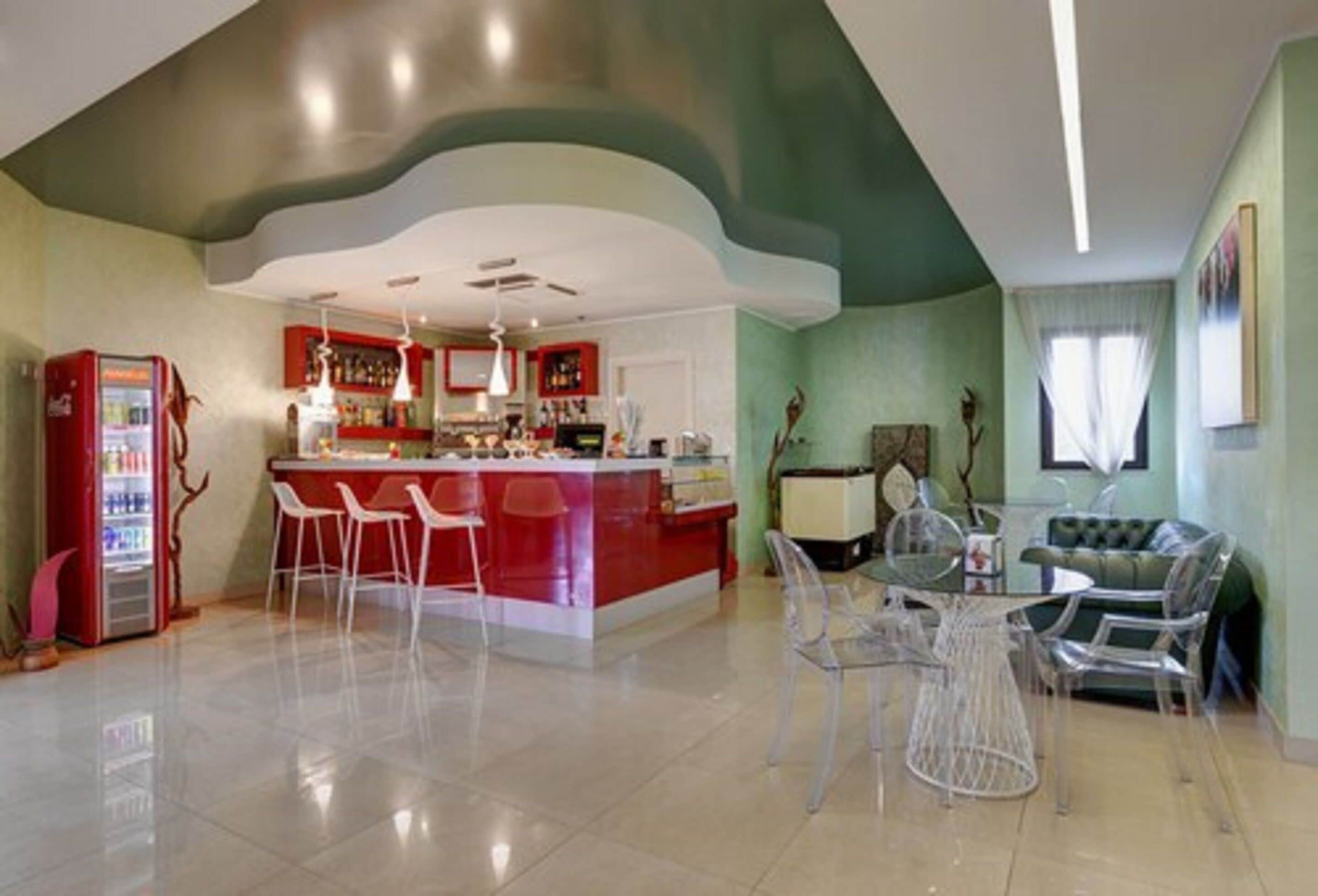 A modern kitchen with a central island, bar area, and seating.