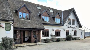 A traditional building with a sign indicating it is a restaurant. - The Airman Hotel (Shefford)