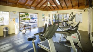 A gym with treadmills, a ceiling fan, and a view of the outside. - Rooms on the Beach Negril (Negril)