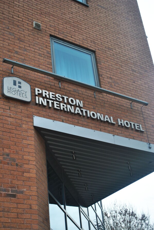 The exterior of Preston International Hotel with a visible sign for Legacy Hotels. - Legacy Preston International Hotel (Preston)