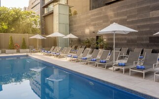 Seasonal outdoor pool, open noon to 8:00 PM, pool umbrellas