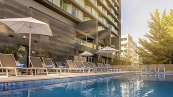 Seasonal outdoor pool, open noon to 8:00 PM, pool umbrellas
