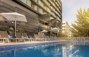 Seasonal outdoor pool, open noon to 8:00 PM, pool umbrellas